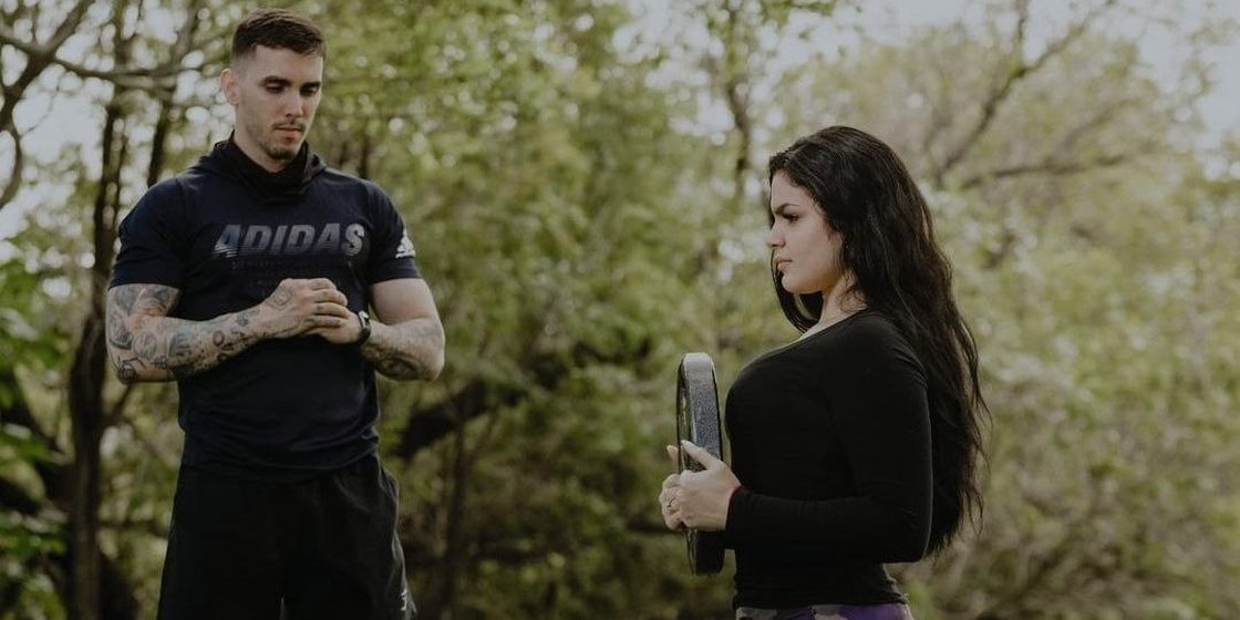 Outdoor coaching session in the park, client mid-lunge